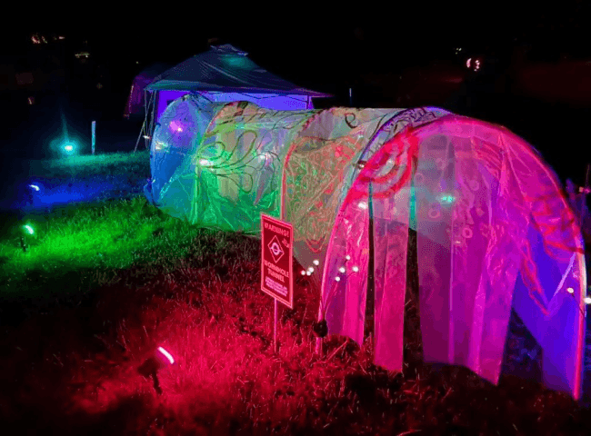 Multicolored glowing tunnel at night